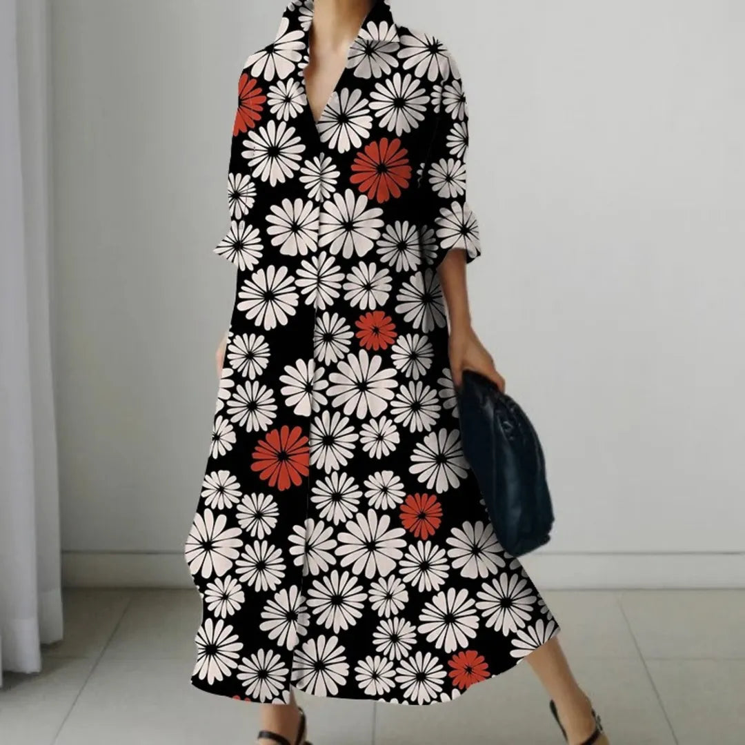 Elegantes schwarzes Kleid mit weißen und roten Blumenmustern, ideal für Damenmode. Perfekt für stilvolle Anlässe und modische Outfits.