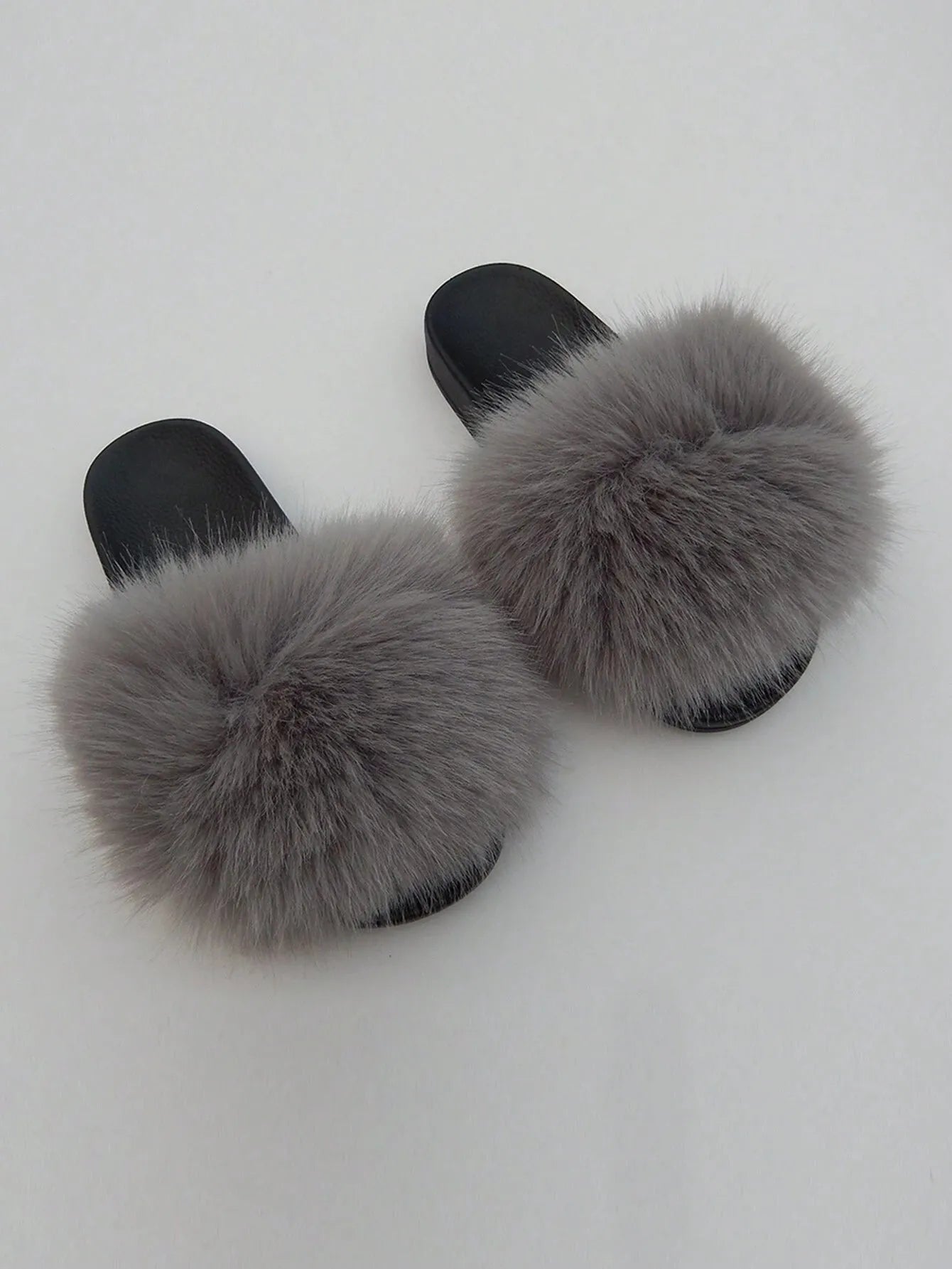 Graue Pelzhausschuhe, flauschig und stilvoll, ideal für gemütliche Wintertage. Perfekte Kombination aus Komfort und Mode für Zuhause.