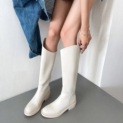 Damenmode: Stilvolle weiße Stiefel aus Leder, kniehoch, kombiniert mit Jeansrock. Trendige Herbst- und Wintermode für elegante Outfits.