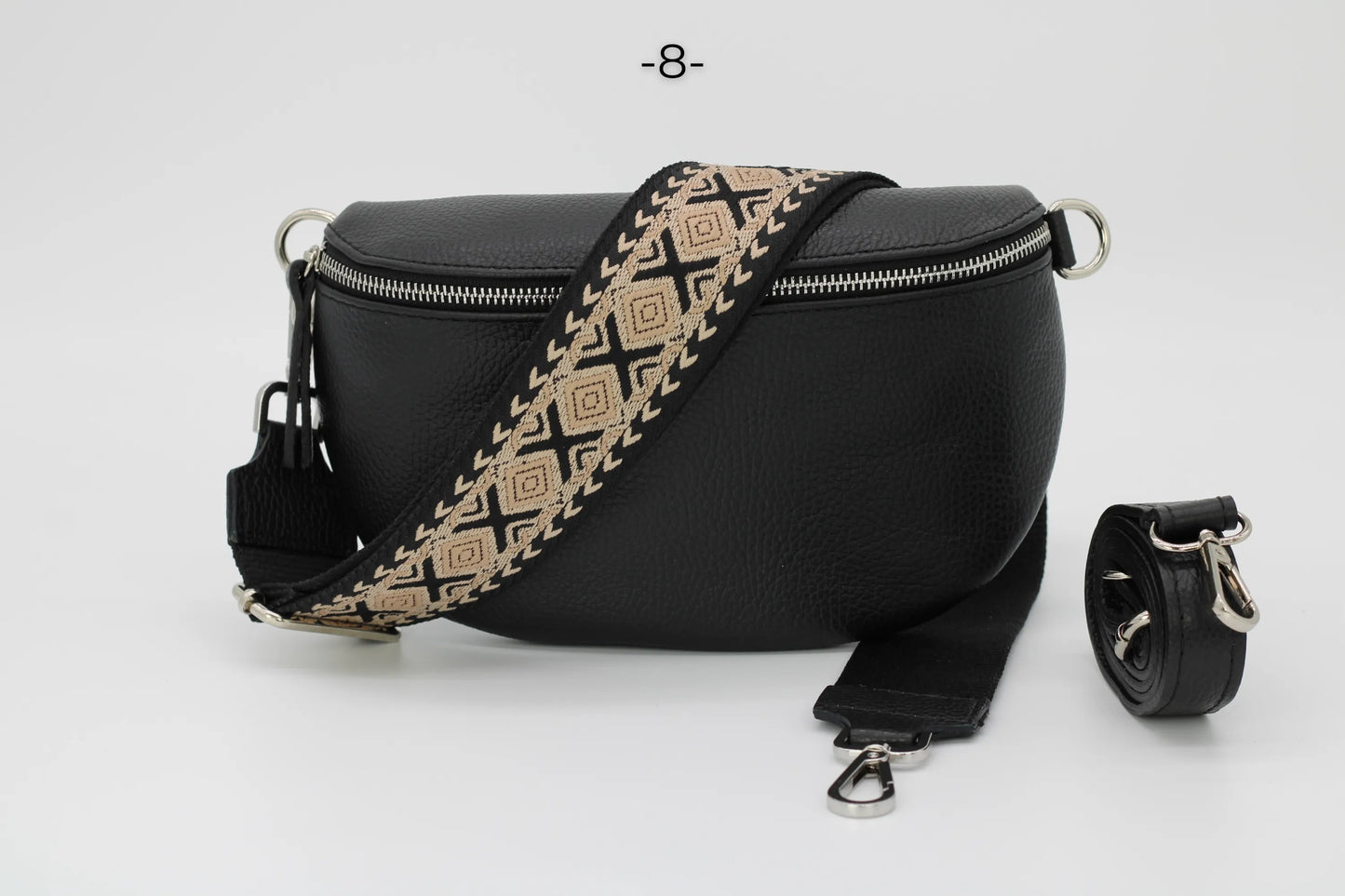 Schwarze Leder-Gürteltasche mit geometrischem Schultergurt, ideal für stilvolle Aufbewahrung. Perfekt für Mode, Accessoires, Damenhandtaschen.