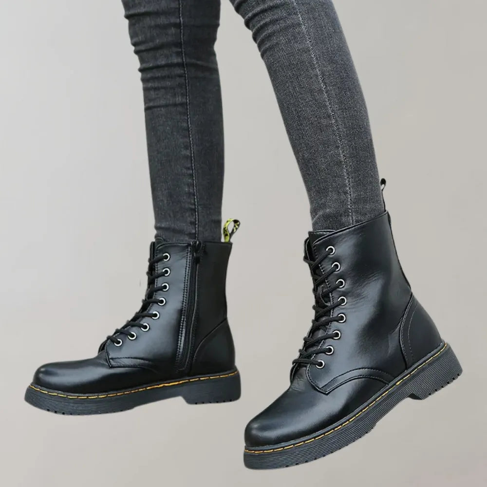 Schwarze Lederstiefel mit Schnürung und Reißverschluss, robustes Design, ideal für Herbstmode. Perfekt kombinierbar mit Jeans und urbanem Stil.