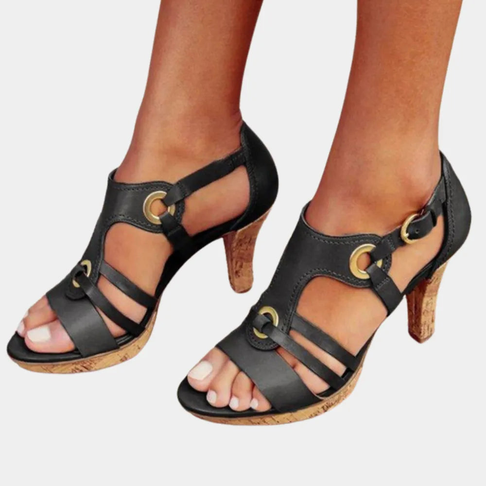 Elegante schwarze Sandaletten mit Korkabsatz und goldenen Schnallen. Perfekt für Sommermode, Damenmode, stilvolle Schuhe, bequeme Absatzschuhe.