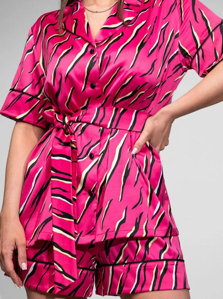 Damen-Pyjama-Set aus Satin in leuchtendem Pink mit modernem Zebra-Muster, kurzärmelig, mit Gürtel. Perfekt für stilvolle Nachtmode.